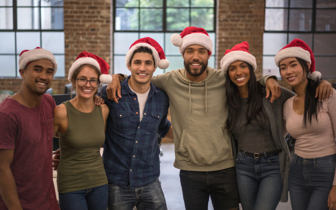 coworkers wearing santa hats to celebrate christmas